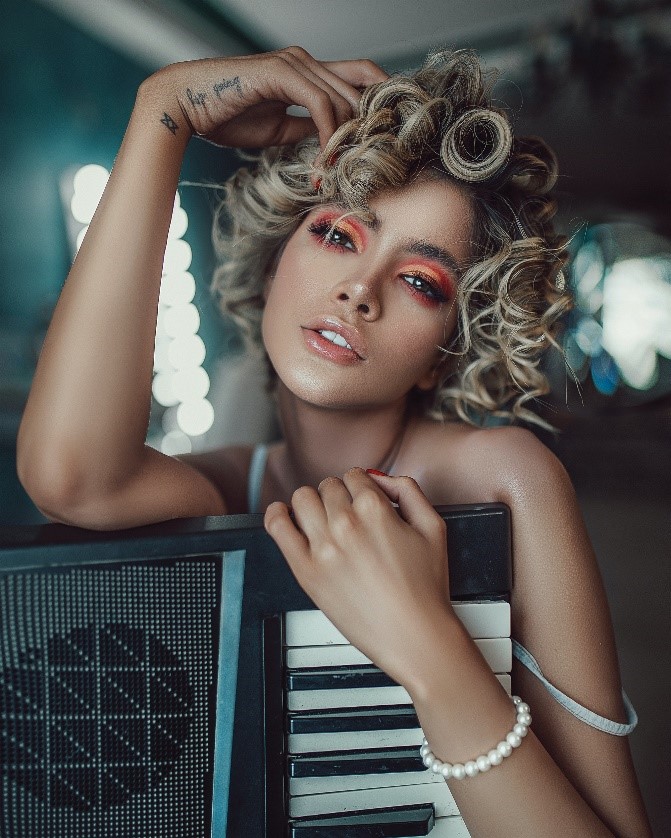 Jeune femme arborant un maquillage intense et coloré sur les yeux.